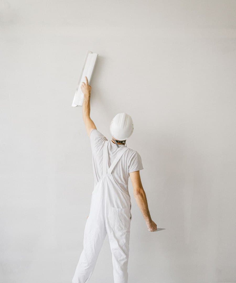 Plasterer finishing a wall with a plastering trowel